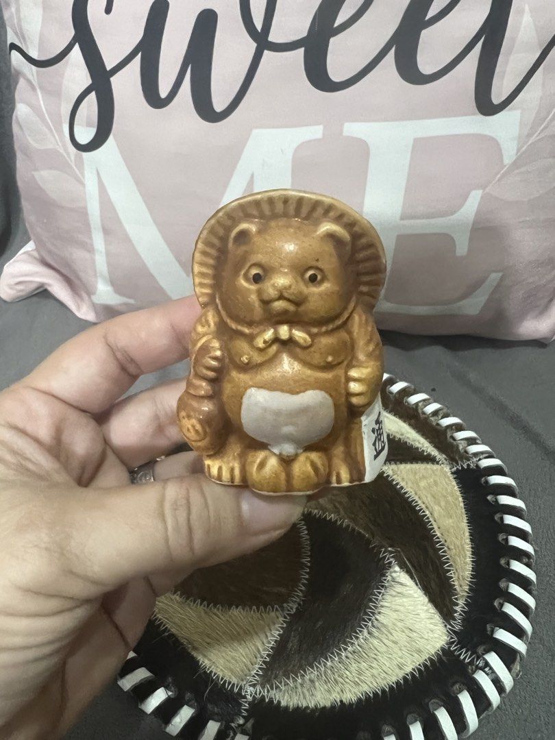 Cute Ceramic Tanuki Figurine (Category: Designer & Blind Box Toys) located in Las Pinas. Submitted by maple0305 (Listing ID 1464047798, Image 1). Description: - Adorable ceramic tanuki statue - Features a traditional hat and a prominent big belly - Small opening at the top, ideal for small plants or as a holder - Adds a charming Japanese aesthetic to any home - Makes a unique and thoughtful gift.