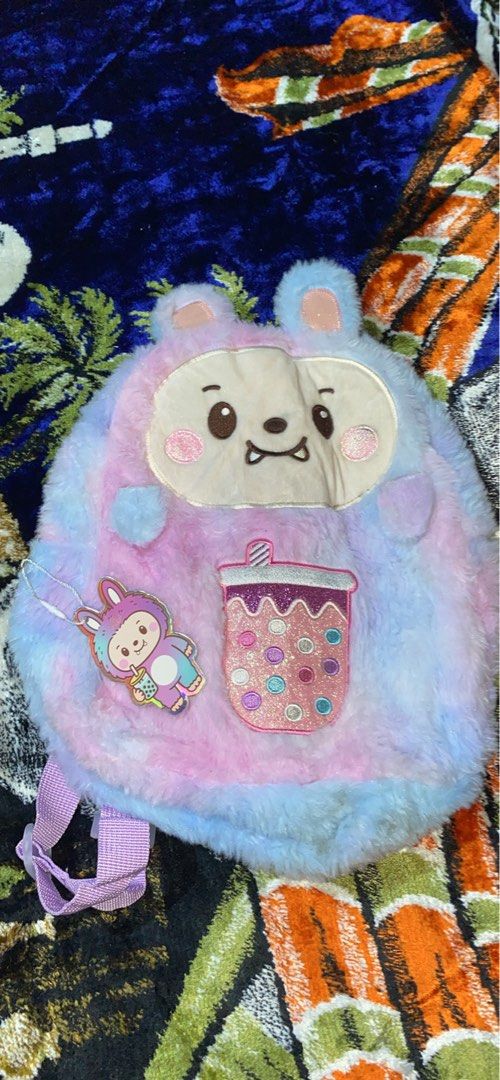 Cute Fluffy Bunny Boba Drink Plush Backpack (Category: Plushies & Soft Toys) located in Manila. Submitted by reginemarquez412 (Listing ID 1464054689, Image 1). Description: - Adorable fluffy backpack - Pastel tie-dye colors (pink & blue) - Features a cute bunny face - Includes a boba drink patch - Comes with a little bunny charm - Adjustable straps for a comfortable fit - Ideal for kids or anyone who loves cute accessories.