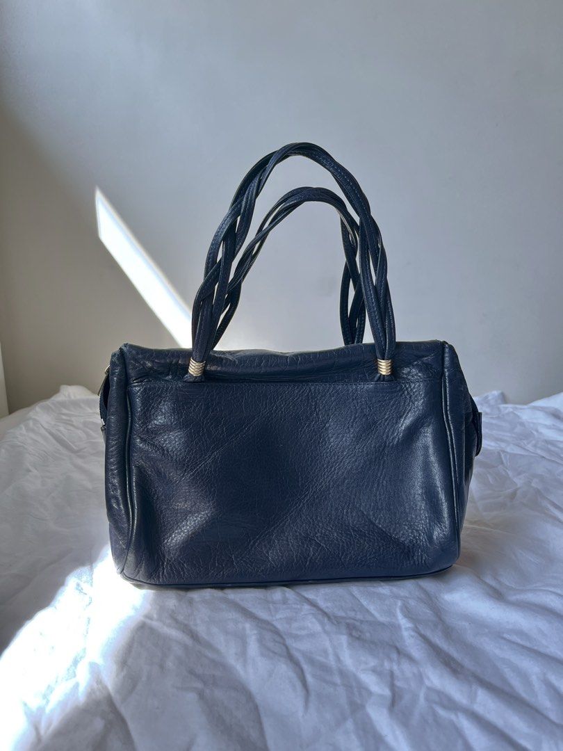 Dark Blue Hand Bag (Category: Purses & Pouches) located in Manila. Submitted by dolledleo (Listing ID 1463974214, Image 1). Description: - Compact - Dark blue color, almost black - Has gold hardware - No flaw .