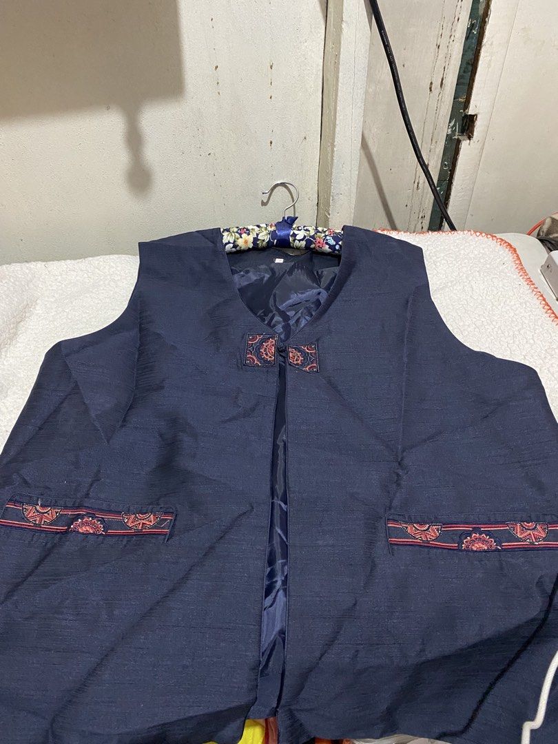 Dark Blue Vest with Red Trim and Pockets (Category: Vests) located in Manila. Submitted by resi.diaz (Listing ID 1464087632, Image 3). Description: - Dark blue V-neck vest - Unique red and gold trim on pockets and front closure - Sleeveless design - Fabric has a slight sheen - Ideal for layering over shirts or dresses.