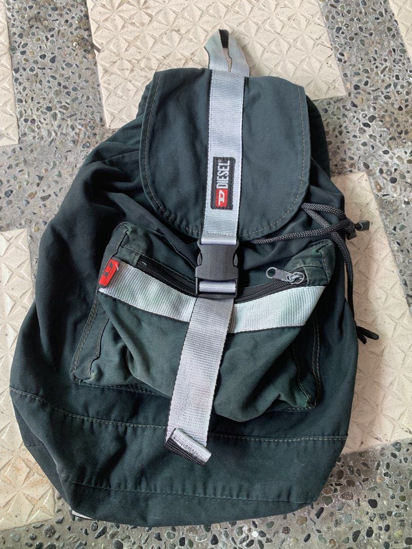 Diesel Backpack Dark Green (Category: Backpacks) located in Manila. Submitted by wildfire.33cd8c (Listing ID 1464126429, Image 1). Description: - Dark green Diesel backpack - Drawstring closure with buckle flap - Front zip pocket - Side pocket - Adjustable straps - Ideal for everyday use or travel.