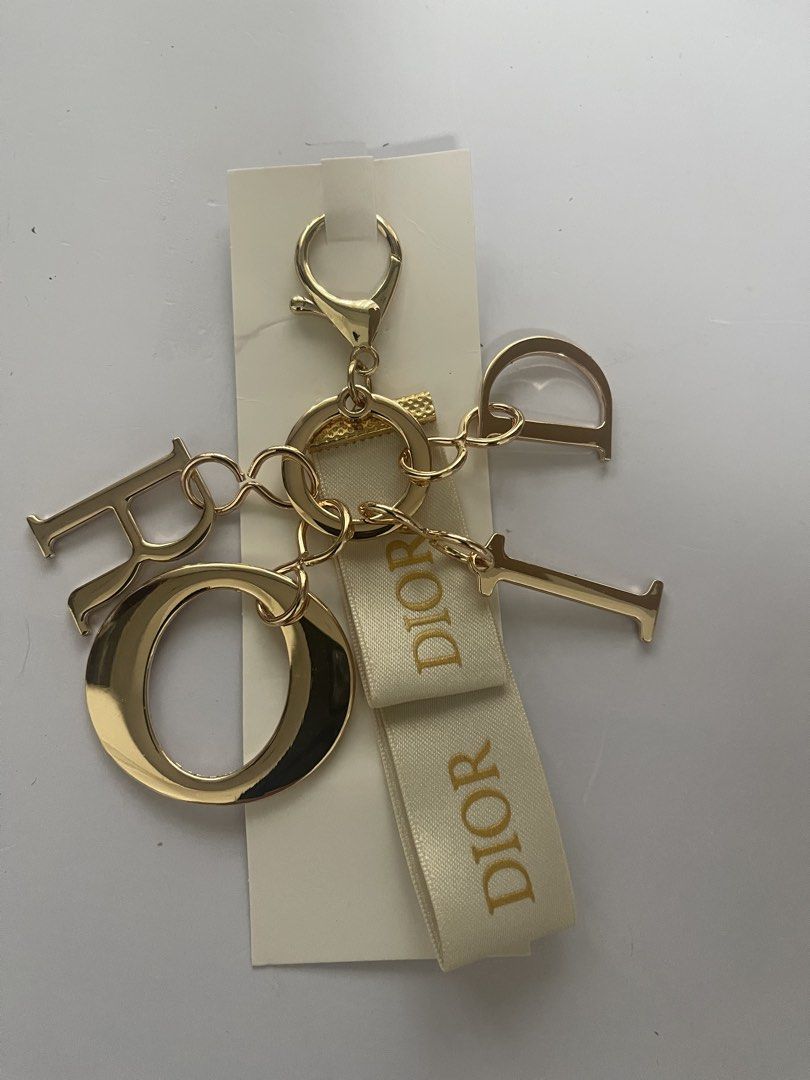 Dior Gold Charm Keychain with Ribbon (Category: Luxury Accessories) located in Quezon City. Submitted by kingcurator (Listing ID 1463990494, Image 3). Description: - Authentic Dior charm keychain - Features iconic Dior logo letters - Elegant ribbon detail - Shiny gold finish - Versatile for bags or keys - Includes original packaging.