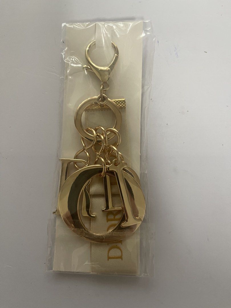 Dior Gold Charm Keychain with Ribbon (Category: Luxury Accessories) located in Quezon City. Submitted by kingcurator (Listing ID 1463990494, Image 2). Description: - Authentic Dior charm keychain - Features iconic Dior logo letters - Elegant ribbon detail - Shiny gold finish - Versatile for bags or keys - Includes original packaging.