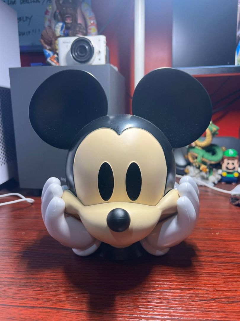 Disney Mickey Mouse Coin bank (Category: Character Goods) located in Baguio. Submitted by ditoyzb08176 (Listing ID 1464060957, Image 1). Description: - Adorable Mickey Mouse coin bank by Disney. - Perfect for saving spare change. - Features an 'Open' cap at the bottom for easy access to savings. - Ideal gift for kids or any Disney enthusiast. Location: BAguio City Shipping: J&T/FLASh/LBC .