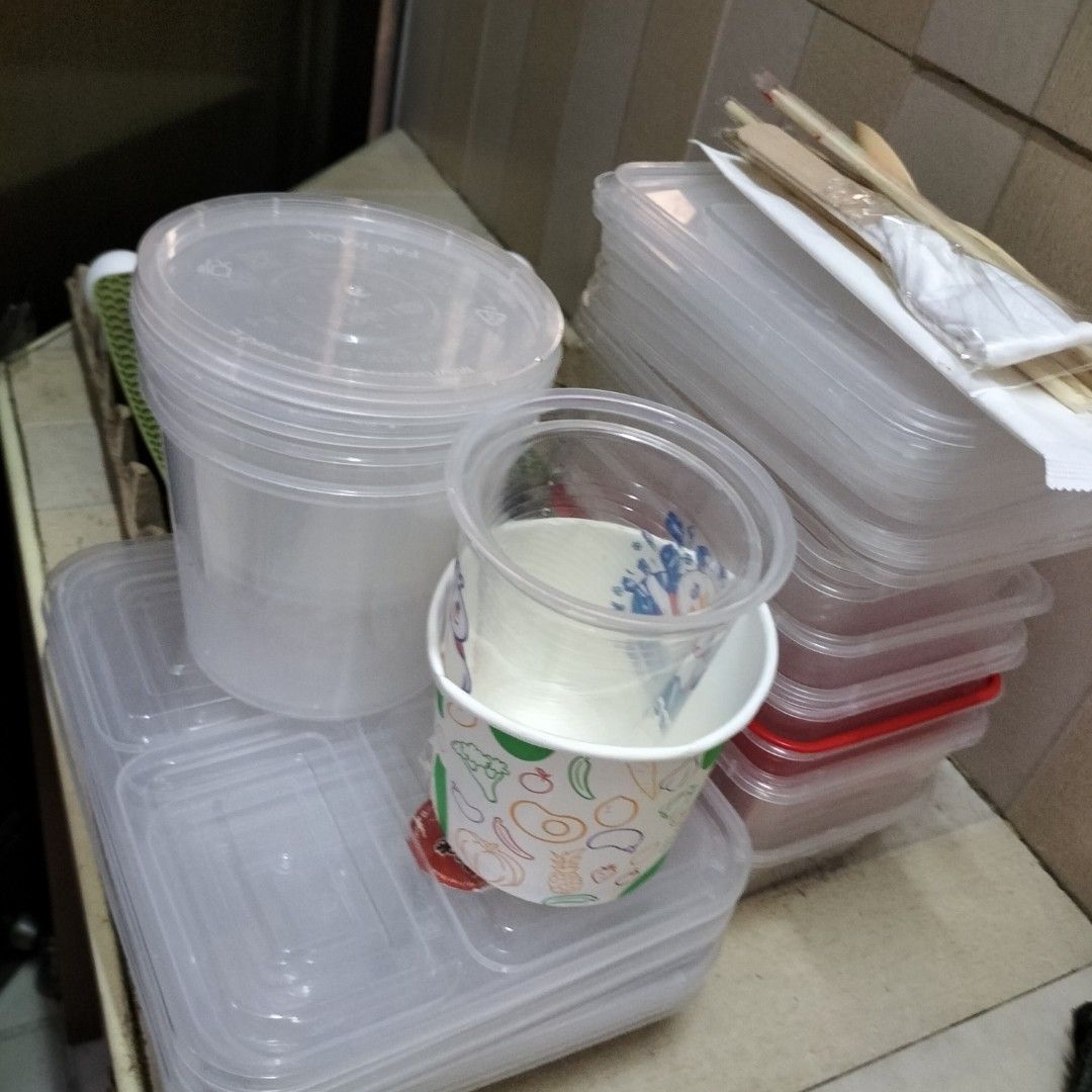 Disposable Food Containers, Cups, and Cutlery Set (Category: Food Organization & Storage) located in Paranaque City. Submitted by decluttering-all (Listing ID 1464132191, Image 2). Description: - Bundle of disposable food containers and cups - Includes various sizes of clear plastic containers with lids - Also includes printed paper cups - Comes with wooden cutlery - Ideal for parties, events, or food business takeaway - All items are clean and r
