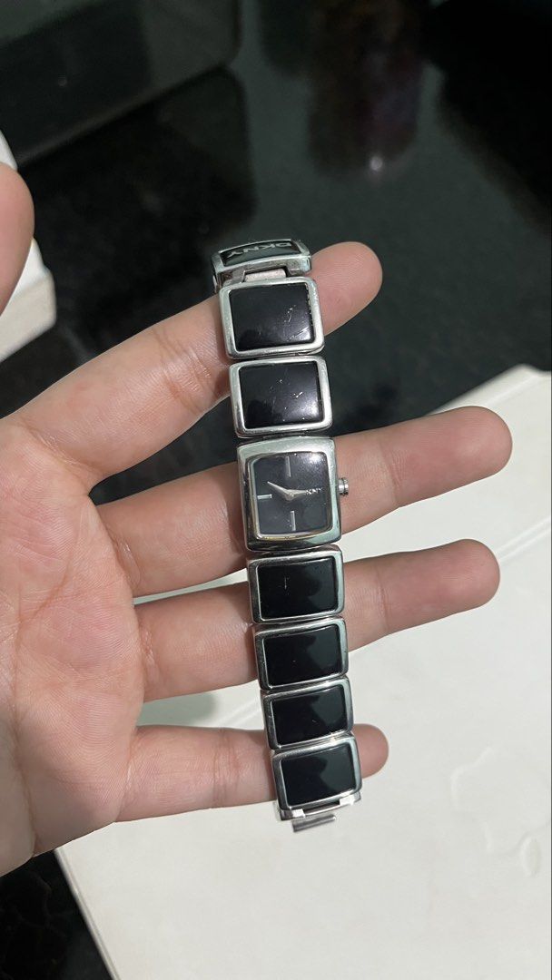DKNY Y2K silver-tone bracelet watch (Category: Women's Watches) located in Lucena. Submitted by needfundsforojt (Listing ID 1463944357, Image 2). Description: (Personal Preloved) DKNY distinctive rectangular black links and a minimalist square black dial. - bought as is - some visible scratches - need battery replacement FREE DELIVERY 📦 NO COD! PAYMENT FIRST ☺️ MOP: Gcash/Landbank/Gotyme Bank.