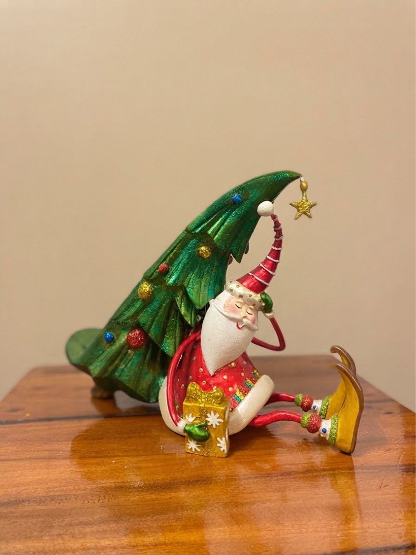 Drunk Santa Claus single-bottled wine holder (Category: Other Home Decor) located in Nagcarlan. Submitted by snccollection (Listing ID 1463973780, Image 1). Description: Christmas Decorative Figurine. Handcrafted polyresin/resin holiday figurine or table accessory. Features a seated, whimsical Santa Claus holding a wrapped gift, leaning back while propping up a decorated green Christmas tree that doubles as a cradle for a wine bottle. RFS: Declut