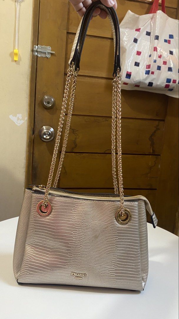 DUNE LONDON BAG CHAIN HANDLE (Category: Shoulder Bags) located in Manila. Submitted by itsaerabella (Listing ID 1463946763, Image 2). Description: PRE-OWNED Dune London Bag Gilded Metallic Chain Strap (Non-tarnish) Bought it for $130 ( 7k plus pesos) Slightly used, looks new pa tlga. What you see is what you get. This bag can be paired with on-trend outfits for a stylish look. minimal issue: yung sa front, my nadikit lang na pandikit, pero hnd nm