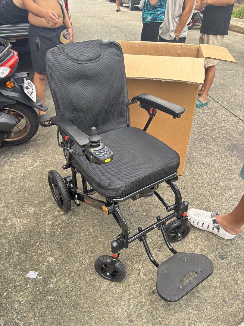 Electric Wheelchair with Joystick Controller (Category: Wheelchairs) located in Manila. Submitted by rosel2001 (Listing ID 1463994664, Image 2). Description: - Electric wheelchair for easy mobility - Intuitive joystick controller for effortless navigation - Comfortable black mesh seat with armrests and footrest - Durable black metal frame - Integrated battery compartment and motor at the back - Comes with charging cable and adapter - Ready for it