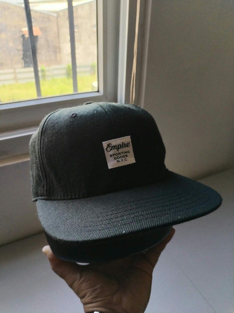 Empire Sporting Goods NYC Snapback Cap Made in USA (Category: Caps & Hats) located in Manila. Submitted by pricendimes_23 (Listing ID 1464070969, Image 1). Description: - Classic black snapback cap - Empire Sporting Goods NYC brand - Features iconic Empire logo on the front - Proudly Made in the USA - Adjustable strap for a custom fit - Ideal for everyday style and comfort.