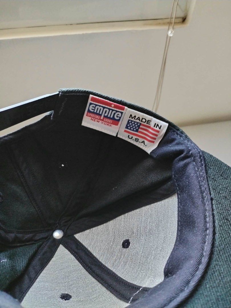 Empire Sporting Goods NYC Snapback Cap Made in USA (Category: Caps & Hats) located in Manila. Submitted by pricendimes_23 (Listing ID 1464070969, Image 3). Description: - Classic black snapback cap - Empire Sporting Goods NYC brand - Features iconic Empire logo on the front - Proudly Made in the USA - Adjustable strap for a custom fit - Ideal for everyday style and comfort.