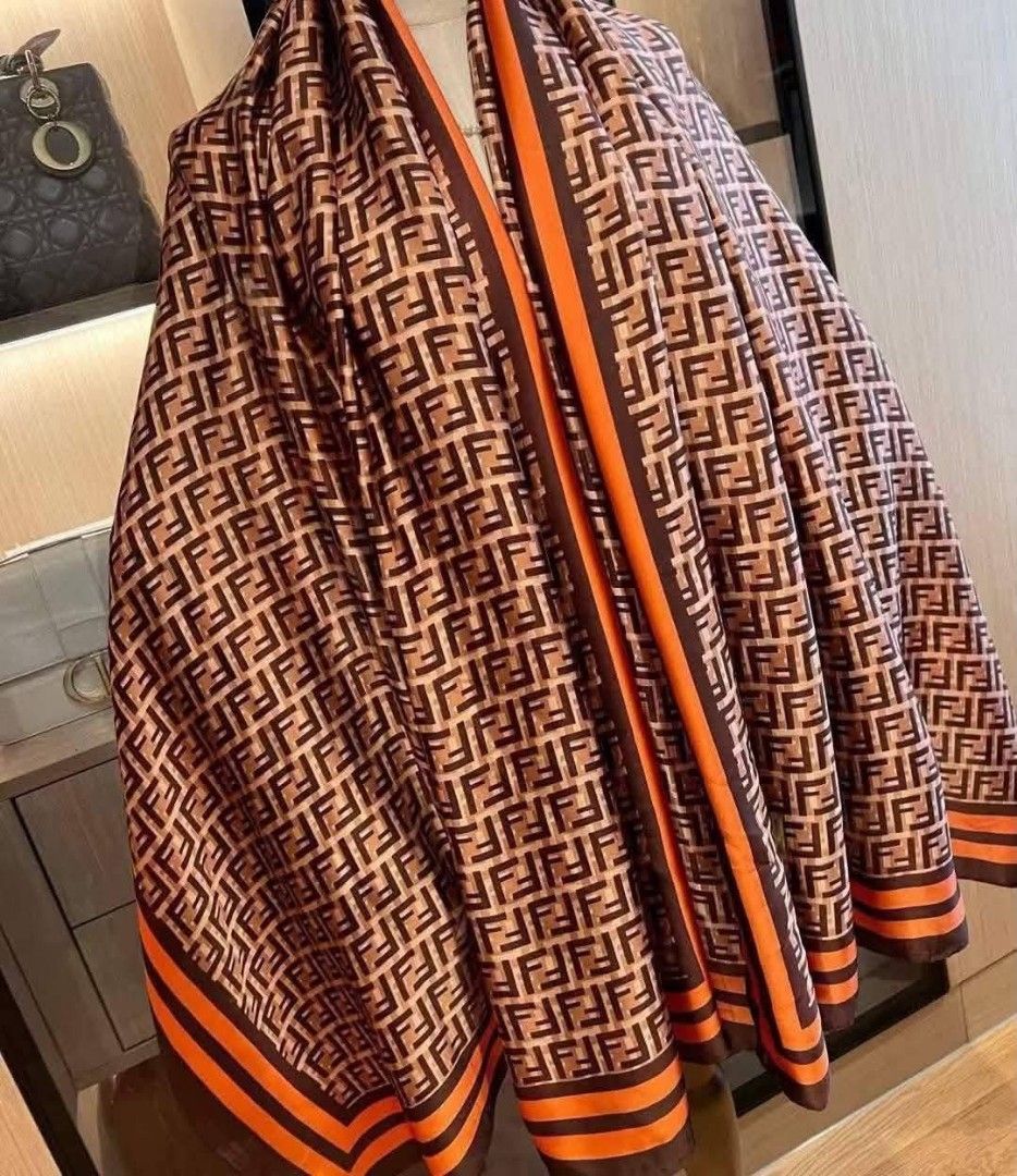 Fendi Dior Silk Scarf Shawl (CLASS A) (Category: Scarves) located in Santo Domingo. Submitted by krizzies_korner (Listing ID 1463976874, Image 1). Description: - Beautiful silk scarves - Features Fendi FF logo print in brown and orange - Also has Dior monogram print in red and blue - One scarf features a detailed jungle print with animals - Soft and smooth material - Perfect for styling.
