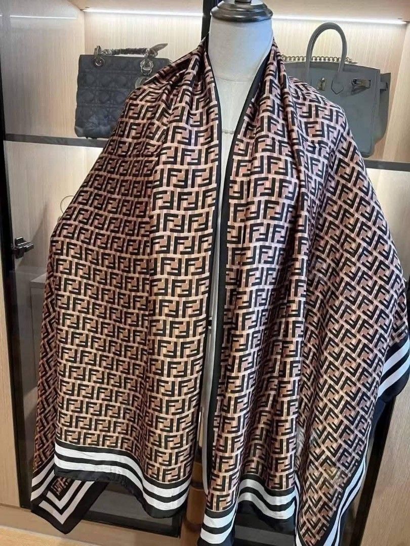 Fendi Dior Silk Scarf Shawl (CLASS A) (Category: Scarves) located in Santo Domingo. Submitted by krizzies_korner (Listing ID 1463976874, Image 2). Description: - Beautiful silk scarves - Features Fendi FF logo print in brown and orange - Also has Dior monogram print in red and blue - One scarf features a detailed jungle print with animals - Soft and smooth material - Perfect for styling.