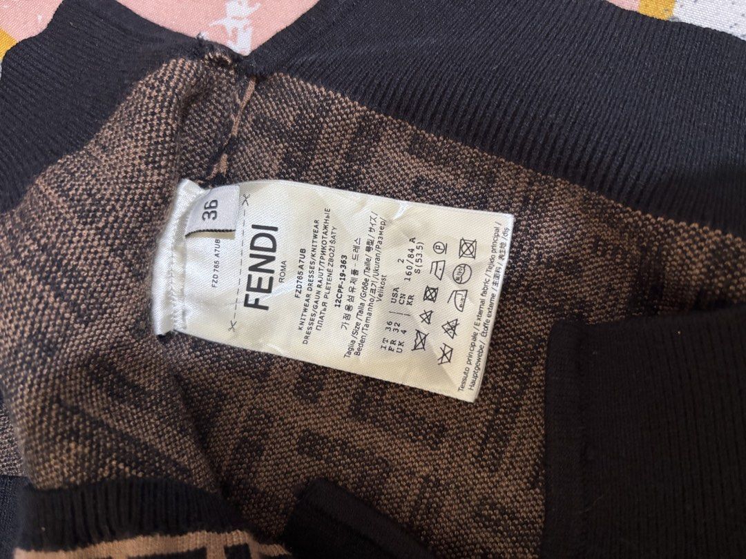 Fendi FF Monogram Knit Top (Category: Blouses) located in Trece Martires City. Submitted by jaynetampo60212 (Listing ID 1463946295, Image 3). Description: - Authentic Fendi knit top - Iconic FF monogram pattern all over - Color: Brown and Black - Style: Short sleeves, crew neck - Details: Ribbed cuffs and hem - Size: 36 - Made in Italy - A must-have for any Fendi enthusiast -best fit for small - medium body frame -stretch fabric -issue lost neck 
