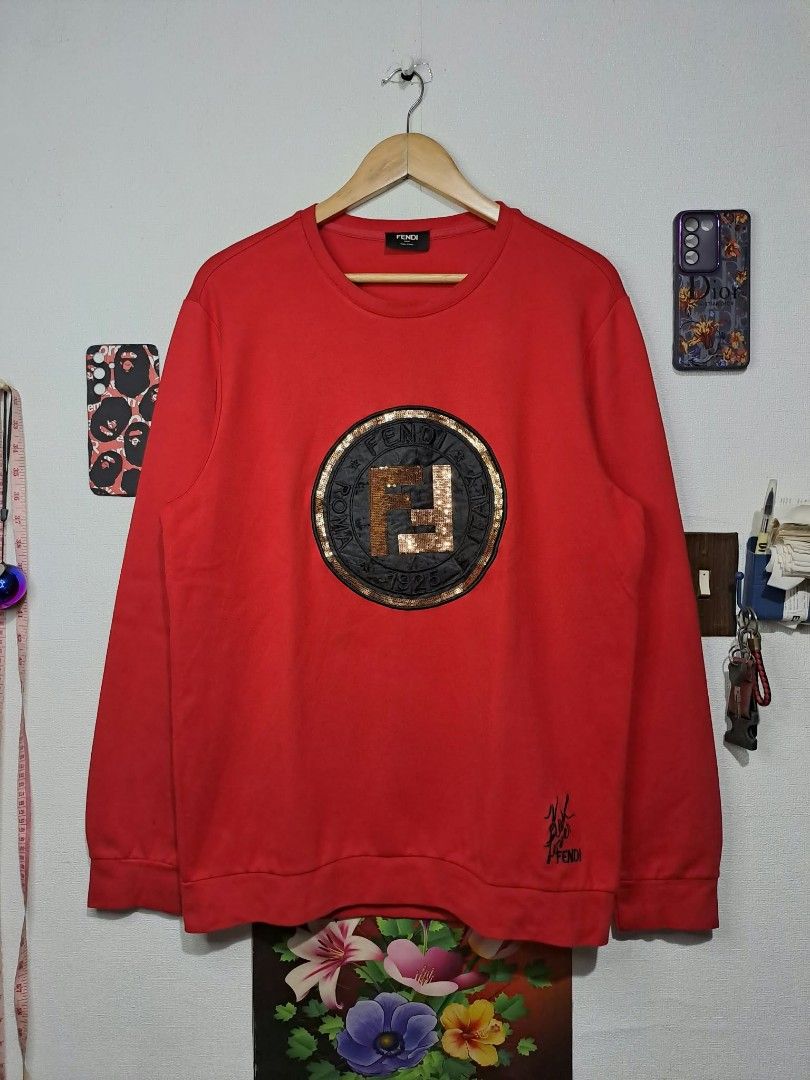 Fendi Roma 1925 x Karl Vibrant Red (Category: Luxury Apparel) located in Quezon City. Submitted by yaseen73 (Listing ID 1464113877, Image 1). Description: Fendi Roma 1925 Circular Logo x Karl Loves Fendi Vibrant Red Sweatshirt With Black Cursive Embroidery "Karl Loves Fendi" Along Side the Classic Brand Logo Cotton Spandex Made in Italy Wearing Size : 2XL on Tag Dimensions : Please Refer to the Photo Needs Re - Wash (With Black Dot Stain on the R
