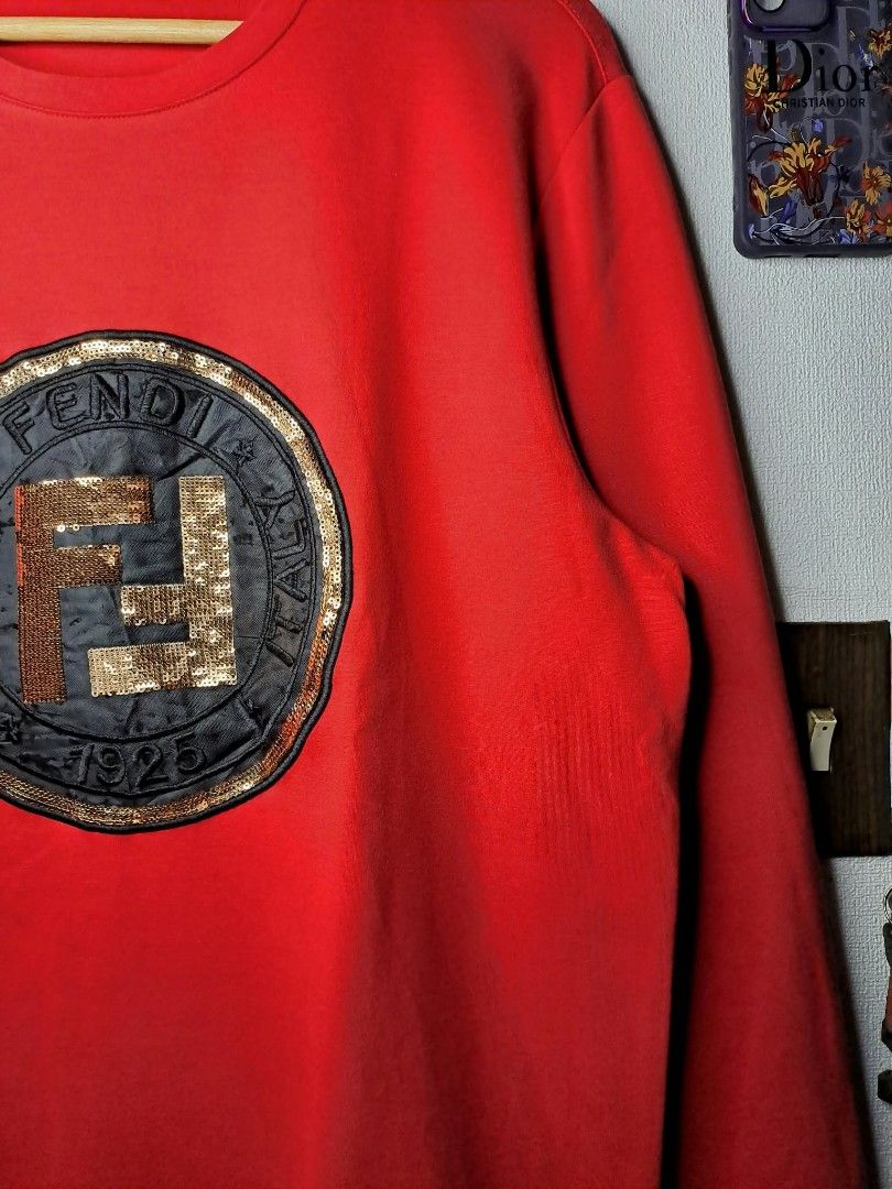 Fendi Roma 1925 x Karl Vibrant Red (Category: Luxury Apparel) located in Quezon City. Submitted by yaseen73 (Listing ID 1464113877, Image 2). Description: Fendi Roma 1925 Circular Logo x Karl Loves Fendi Vibrant Red Sweatshirt With Black Cursive Embroidery "Karl Loves Fendi" Along Side the Classic Brand Logo Cotton Spandex Made in Italy Wearing Size : 2XL on Tag Dimensions : Please Refer to the Photo Needs Re - Wash (With Black Dot Stain on the R