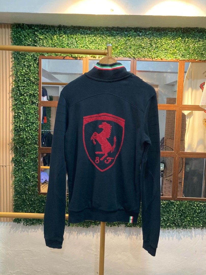 Ferrari Puma Track Jacket (Category: Coats, Jackets and Outerwear) located in Trece Martires City. Submitted by djaothriftshop (Listing ID 1463973296, Image 2). Description: - Authentic Ferrari Puma Track Jacket - Iconic Ferrari shield logo on front and back - Puma logo detail on the front - Comfortable ribbed collar and cuffs - Two secure front pockets with zip closure - Ideal for any Scuderia Ferrari enthusiast.
