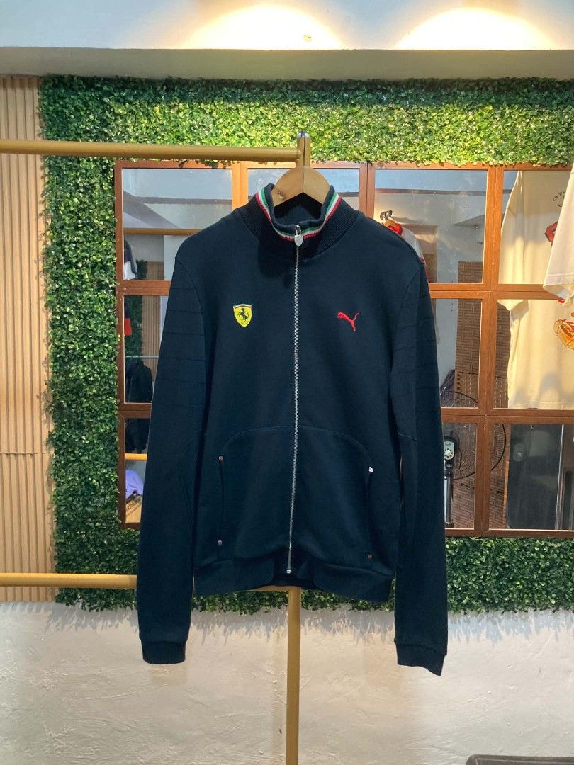 Ferrari Puma Track Jacket (Category: Coats, Jackets and Outerwear) located in Trece Martires City. Submitted by djaothriftshop (Listing ID 1463973296, Image 1). Description: - Authentic Ferrari Puma Track Jacket - Iconic Ferrari shield logo on front and back - Puma logo detail on the front - Comfortable ribbed collar and cuffs - Two secure front pockets with zip closure - Ideal for any Scuderia Ferrari enthusiast.