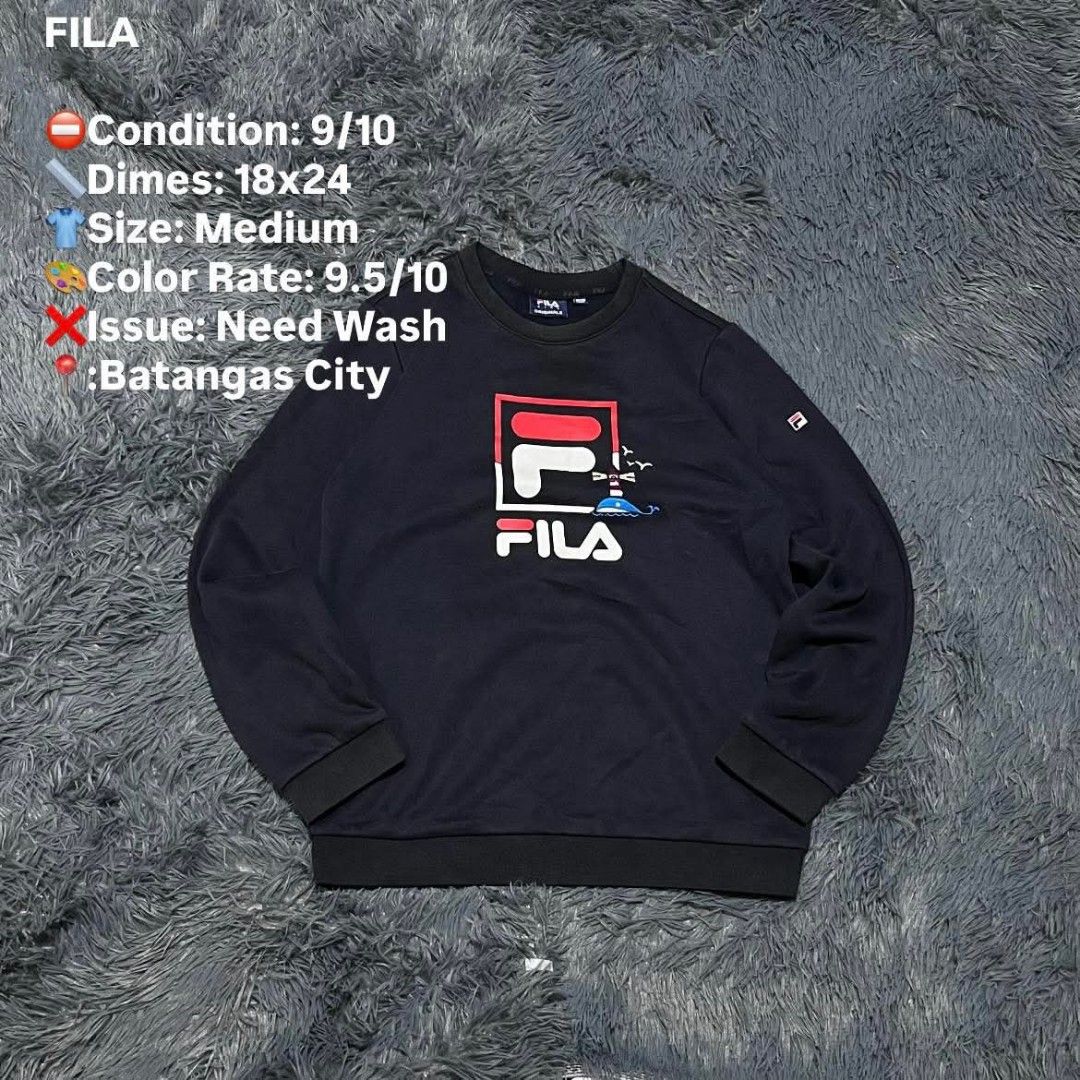 FILA Navy Blue Sweatshirt Size Medium (Category: Coats, Jackets and Outerwear) located in Batangas. Submitted by jaylord_g (Listing ID 1464111291, Image 1). Description: - Navy blue FILA sweatshirt - Size: Medium - Features classic FILA logo with a fun graphic - Dimensions: 18x24 inches - Location: Batangas City - Item needs a wash.