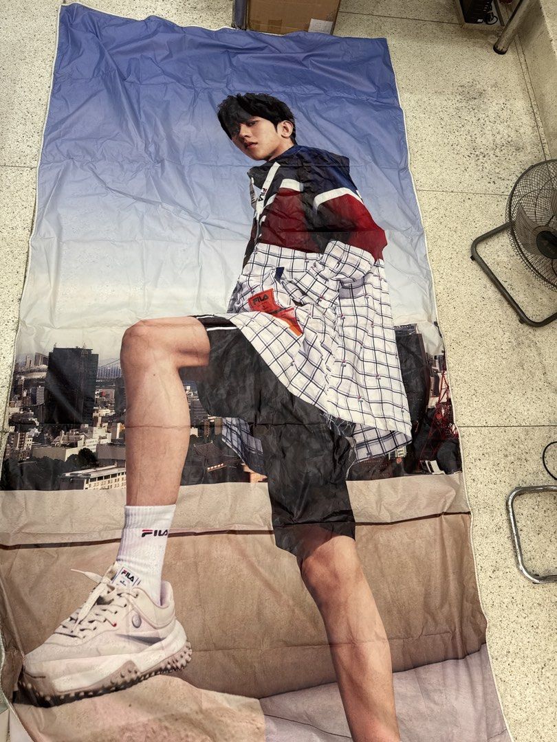 Fila Tapestry with Model Print (Category: Wall Decor) located in Malabon City. Submitted by emperorseraph (Listing ID 1463949056, Image 1). Description: - Large Fila tapestry - Features a male model in Fila apparel and sneakers - Cityscape background - Made of fabric material - Perfect for wall decor or as a statement piece.