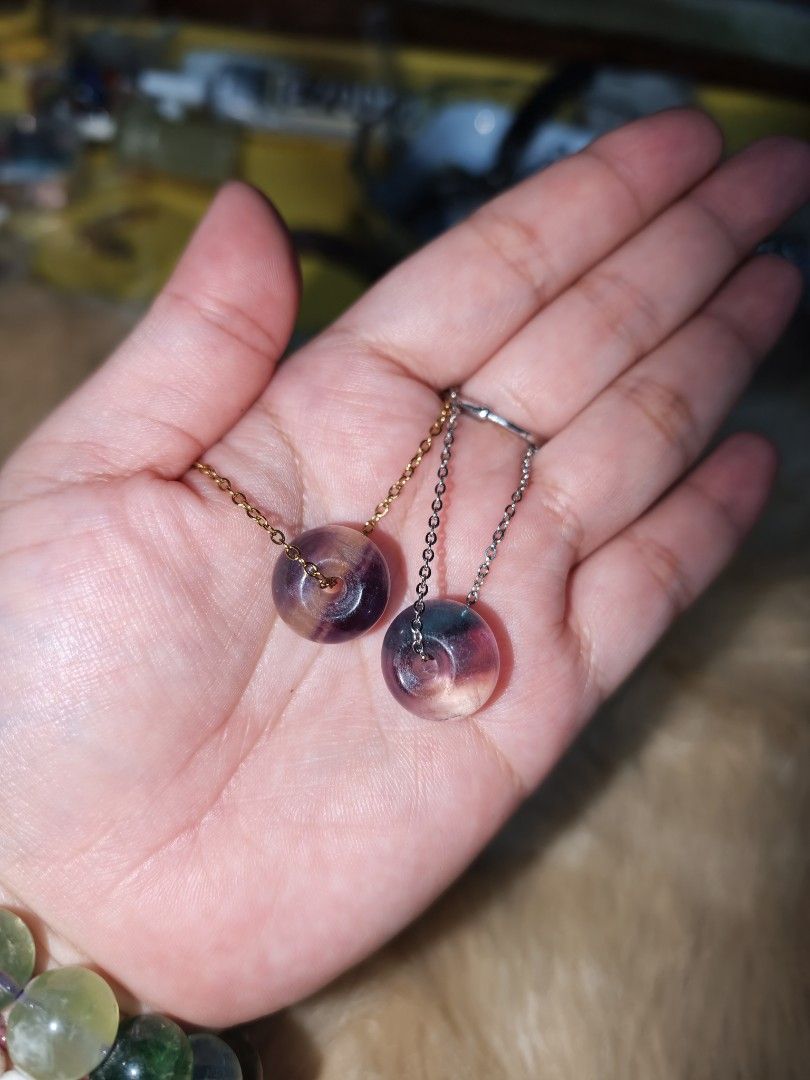 Fluorite Donut Pendant (Category: Necklaces) located in Quezon City. Submitted by piaoliangcollections.ph (Listing ID 1463952458, Image 2). Description: Each one is 3k. Made from Natural Fluorite Stone. Get it Now. Fluorite is widely known in crystal healing as the "Stone of Genius" for its ability to clear mental clutter and boost focus. Mental and Emotional Benefits Mental Clarity: Helps cut through scattered, noisy thoughts to improve concentr