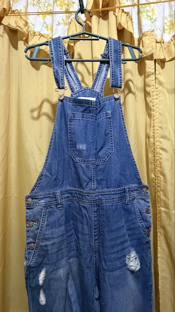 Forever 21 Blue Denim Distressed Overalls (Category: Jumpsuits) located in Manila. Submitted by nayeoniescart (Listing ID 1464104959, Image 2). Description: PRE LOVED: Forever 21 blue denim overalls MOD: jnt / MOP: gcash Size: US 30 / EU 44 - Distressed look with rips on legs and bib - Adjustable straps - Button closures on sides - Multiple front and back pockets - Ideal for a casual, edgy style.