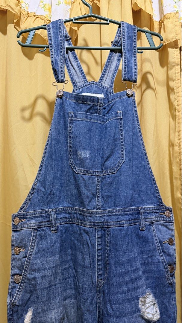 Forever 21 Blue Denim Distressed Overalls (Category: Jumpsuits) located in Manila. Submitted by nayeoniescart (Listing ID 1464104959, Image 1). Description: PRE LOVED: Forever 21 blue denim overalls MOD: jnt / MOP: gcash Size: US 30 / EU 44 - Distressed look with rips on legs and bib - Adjustable straps - Button closures on sides - Multiple front and back pockets - Ideal for a casual, edgy style.