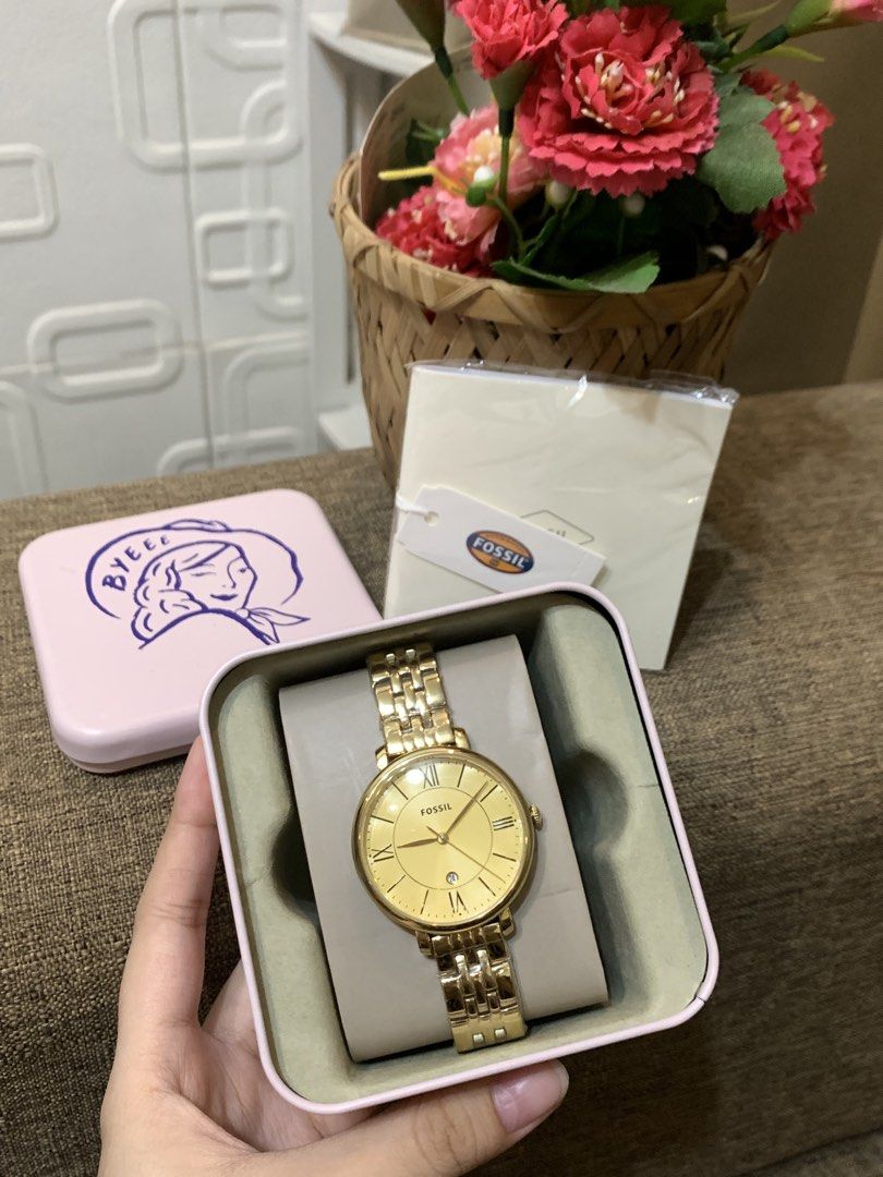 Fossil Watch (Category: Women's Watches) located in Manila. Submitted by jei_sol (Listing ID 1464061206, Image 2). Description: - Genuine Gold Fossil Watch - Durable Stainless Steel Band - Elegant Roman Numeral Hour Markers - Convenient Date Window - Includes Original Fossil Tin and Box - Brand New with Tag Still Attached - Versatile: Ideal for Daily Wear or Special Occasions RFS: Urgent Decluttering BRAND NEW! .