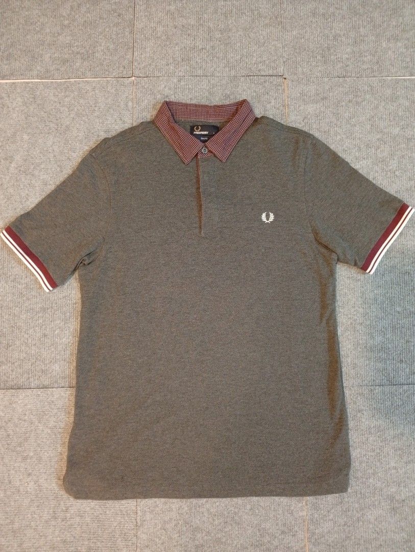 Fred Perry Polo Shirt - Grey with Checked Collar (Category: Tshirts & Polo Shirts ) located in Cebu City. Submitted by jeanyrose46 (Listing ID 1463961076, Image 1). Description: - Grey Fred Perry polo shirt - Iconic laurel wreath logo on chest - Subtle maroon and white checked collar - Maroon and white striped sleeve cuffs - Versatile for casual and smart-casual outfits.