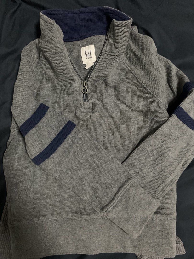 GAP Kids Grey Quarter Zip Sweater (Category: Babies & Kids Fashion) located in Malabon City. Submitted by vewonica (Listing ID 1464137531, Image 3). Description: - GAP Kids quarter zip sweater - Size: XS (fits 4-6 years old) - Color: Grey with navy blue accents on collar and sleeves - Features: Chest pocket with zip closure - Material: Ribbed texture - Origin: Made in Indonesia - Perfect for layering.