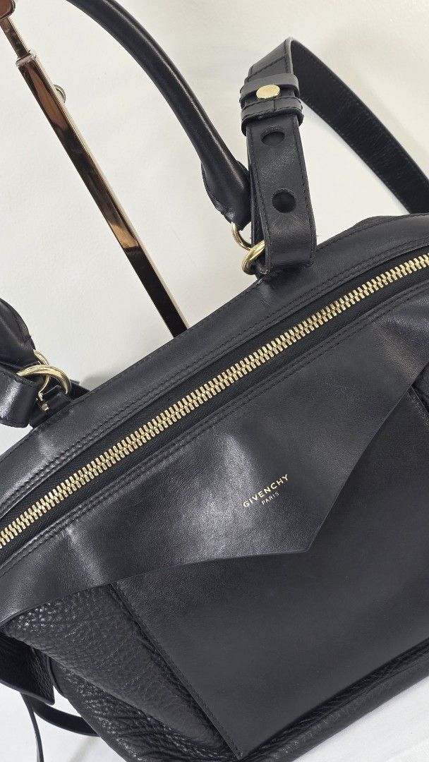Givenchy Black Leather SWAY (Category: Luxury Bags & Wallets) located in San Fernando. Submitted by bagproject (Listing ID 1464125848, Image 2). Description: - Authentic Givenchy Nightingale handbag - Color: Black - Material: Textured leather - Features: Top handles and a detachable shoulder strap - Hardware: Gold-tone - Interior: Spacious, perfect for essentials - Style: Classic designer piece.