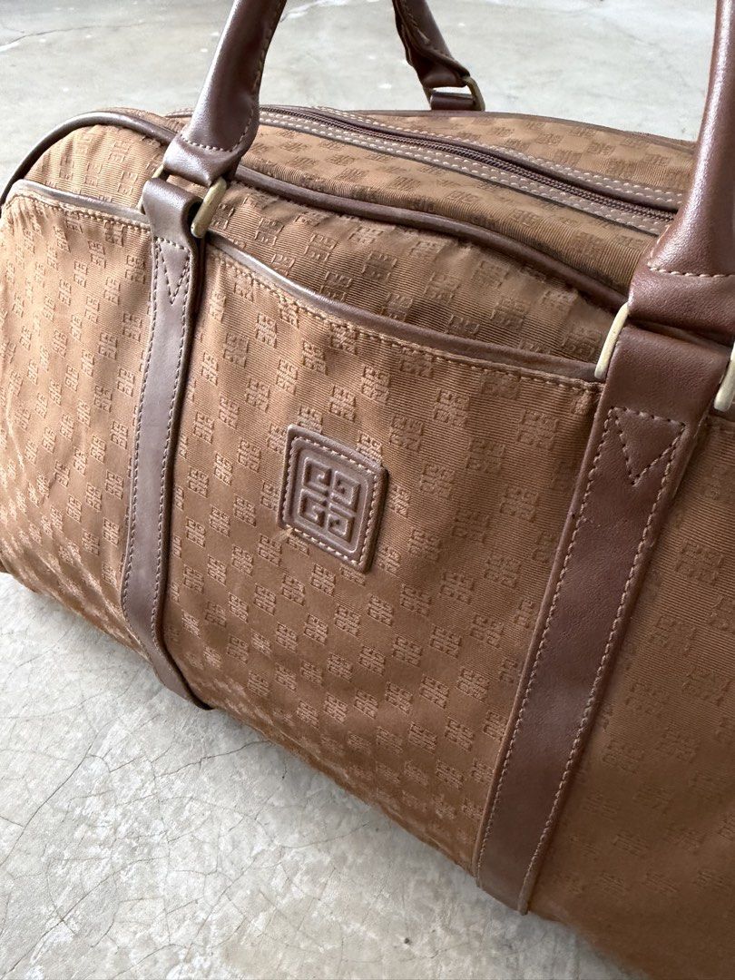Givenchy Monogram Canvas Leather Trim Duffle Bag (Category: Luxury Bags & Wallets) located in Alfonso. Submitted by jbcamet (Listing ID 1464022294, Image 2). Description: - Authentic Givenchy brown canvas duffle bag - Features signature monogram pattern - Durable leather trim and handles - Secure zipper closure - Interior zippered pocket for essentials - Ideal for weekend trips or as a carry-on - Spacious and fashionable design - Note: Shows some