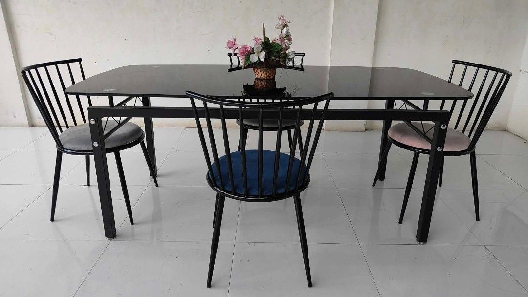 Glass-Top 4-Seater Dining Set (Category: Tables & Sets) located in Mexico. Submitted by mgracejapansurplus (Listing ID 1464044508, Image 3). Description: NEW ARRIVAL 🔥 JAPAN SURPLUS 🇯🇵 ▪️Glass-Top 4-Seater Dining Set ✨ - Sleek black glass top. - Sturdy black steel frame, modern minimalist design. - 4 chairs with black metal spindle backs & multi-color soft fabric seats - Contemporary style, spacious & easy to maintain. Dimensions: L71" × W35" 