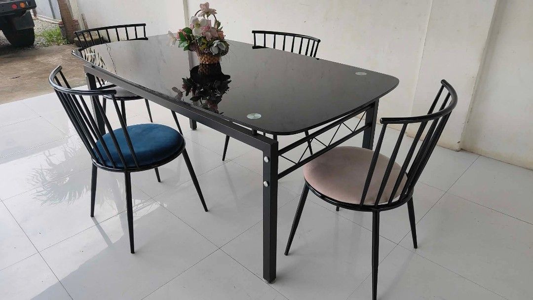 Glass-Top 4-Seater Dining Set (Category: Tables & Sets) located in Mexico. Submitted by mgracejapansurplus (Listing ID 1464044508, Image 2). Description: NEW ARRIVAL 🔥 JAPAN SURPLUS 🇯🇵 ▪️Glass-Top 4-Seater Dining Set ✨ - Sleek black glass top. - Sturdy black steel frame, modern minimalist design. - 4 chairs with black metal spindle backs & multi-color soft fabric seats - Contemporary style, spacious & easy to maintain. Dimensions: L71" × W35" 