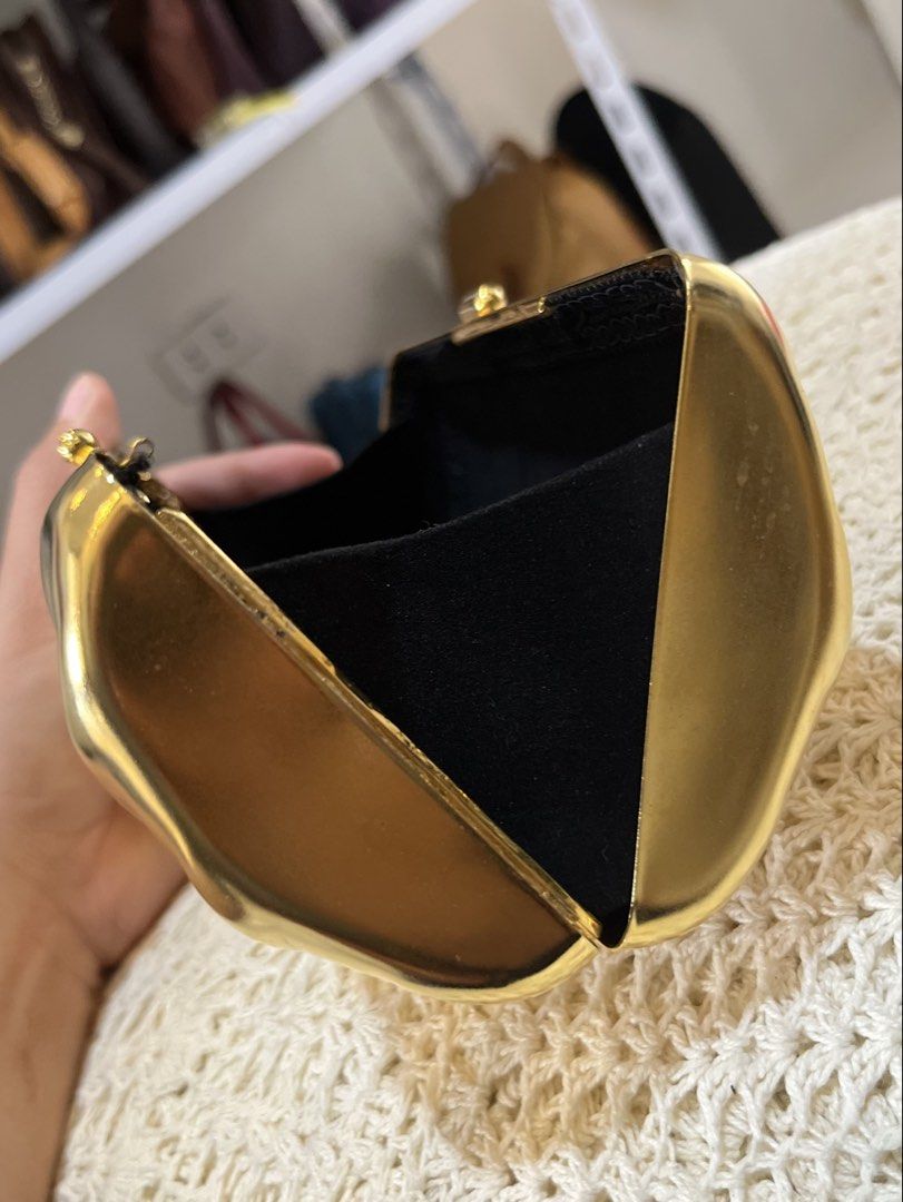 Gold Chevron Clutch Bag with Chain (Category: Luxury Bags & Wallets) located in Bacolod City. Submitted by vintage_vogue6100 (Listing ID 1464017378, Image 3). Description: - Stunning shiny gold clutch bag - Elegant chevron pattern all over - Secure clasp closure - Includes a detachable gold chain strap - Lined with soft black velvet interior - Compact size: 19cm (L) x 9cm (H) x 6cm (W).