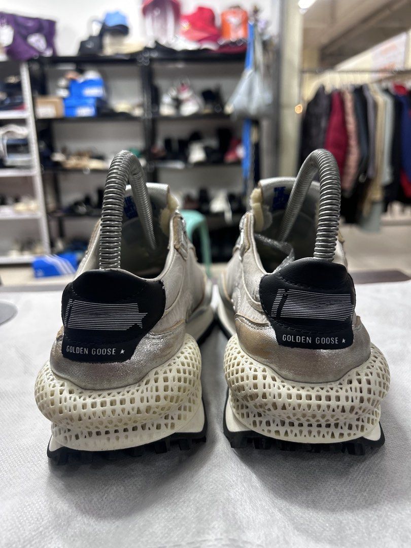 Golden Goose Marathoner Sneakers Silver (Category: Sneakers) located in Pasig City. Submitted by blitzkriegspc (Listing ID 1464136269, Image 2). Description: - Brand: Golden Goose - Model: Marathoner - Size: 40 - Color: Silver with black accents - Key Feature: Unique 3D printed sole - Style: Edgy, statement piece.