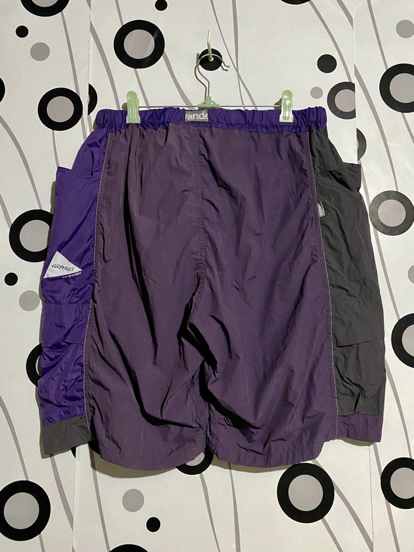 Gramicci x and Wander Patchwork Wind Shorts (Category: Shorts) located in Cebu City. Submitted by patspickph (Listing ID 1464058543, Image 2). Description: This is a Gramicci x and Wander Patchwork Wind Shorts in the Multi Purple colorway.The shorts feature a panelled, mixed-purple design combining high-density and ripstop nylon, an integrated webbing belt with co-branded details, and dual cargo flap pockets on the legs. Size L on tag Free size w