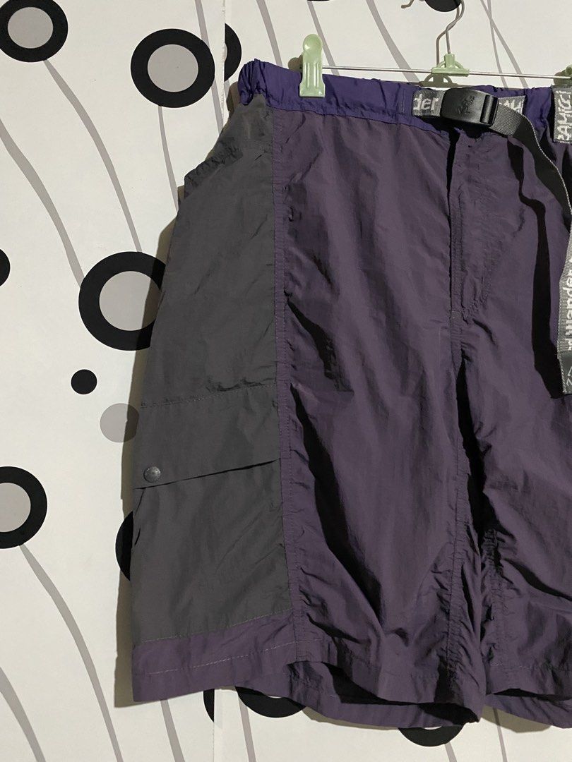 Gramicci x and Wander Patchwork Wind Shorts (Category: Shorts) located in Cebu City. Submitted by patspickph (Listing ID 1464058543, Image 3). Description: This is a Gramicci x and Wander Patchwork Wind Shorts in the Multi Purple colorway.The shorts feature a panelled, mixed-purple design combining high-density and ripstop nylon, an integrated webbing belt with co-branded details, and dual cargo flap pockets on the legs. Size L on tag Free size w