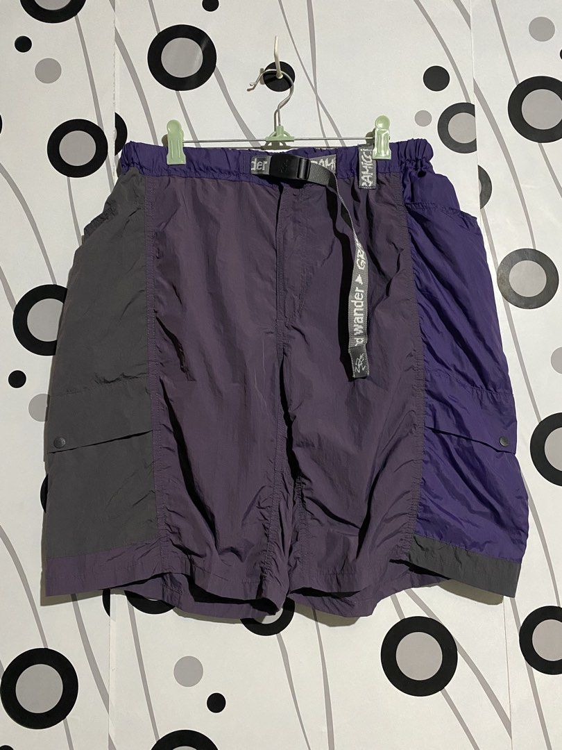 Gramicci x and Wander Patchwork Wind Shorts (Category: Shorts) located in Cebu City. Submitted by patspickph (Listing ID 1464058543, Image 1). Description: This is a Gramicci x and Wander Patchwork Wind Shorts in the Multi Purple colorway.The shorts feature a panelled, mixed-purple design combining high-density and ripstop nylon, an integrated webbing belt with co-branded details, and dual cargo flap pockets on the legs. Size L on tag Free size w