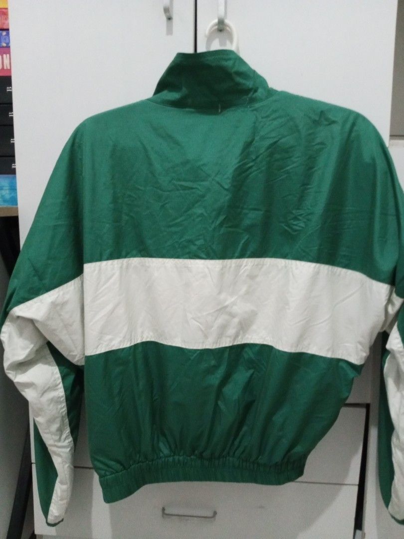 Green and White Track Jacket (Category: Coats, Jackets and Outerwear) located in Manila. Submitted by lofiley (Listing ID 1464030298, Image 2). Description: - Classic green and white design - Full zip front closure - Two convenient side pockets - Elasticated cuffs and hem for a snug fit - Lightweight material, ideal for comfort - Versatile for casual wear or athletic activities.