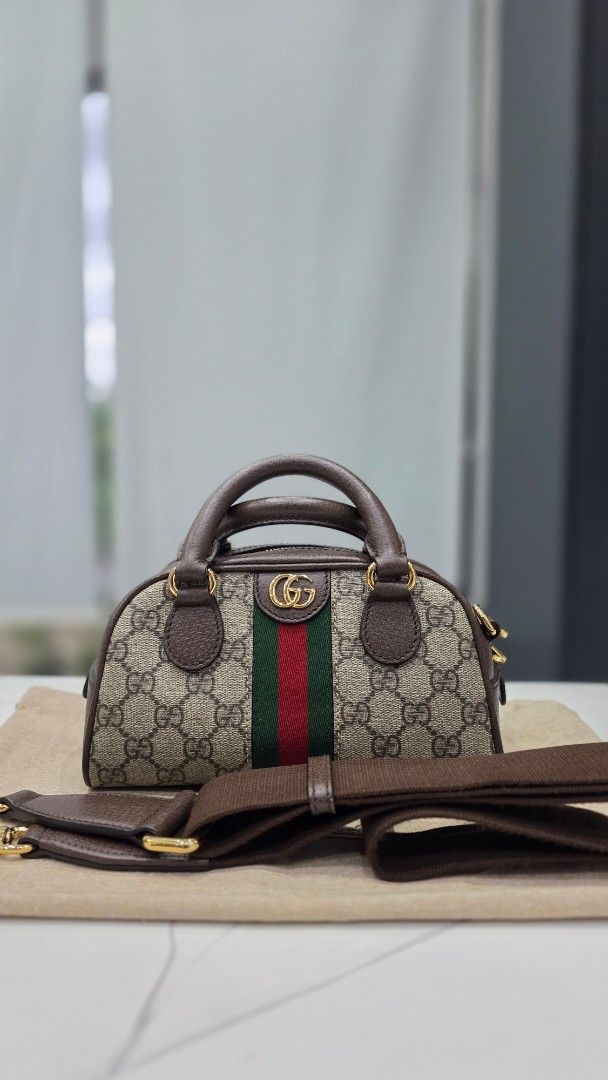 Gucci Ophidia GG Mini Duffle Bag (Category: Luxury Bags & Wallets) located in San Fernando. Submitted by bagproject (Listing ID 1464060907, Image 1). Description: - Authentic Gucci mini duffle bag - Classic GG monogram canvas - Signature green and red stripe detail - Brown leather trim and handles - Detachable shoulder strap included - Gold hardware - Ideal for everyday use or a night out.