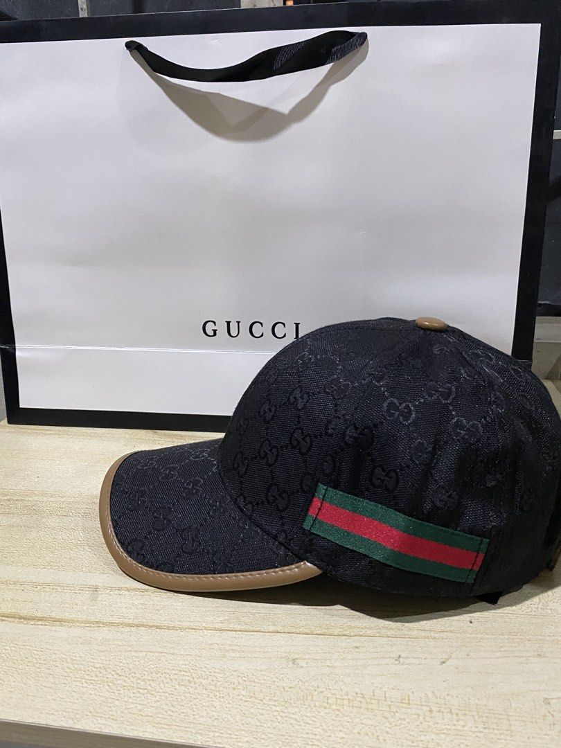 Gucci Original GG Canvas Baseball Cap (Category: Caps & Hats) located in Quezon City. Submitted by carlos132 (Listing ID 1464123161, Image 2). Description: - Iconic Gucci cap with GG monogram pattern - Features classic green and red stripe detail - Made in Italy - Genuine leather trim - Adjustable strap for a comfortable fit - Comes with original Gucci dust bag - Perfect accessory to elevate any look.