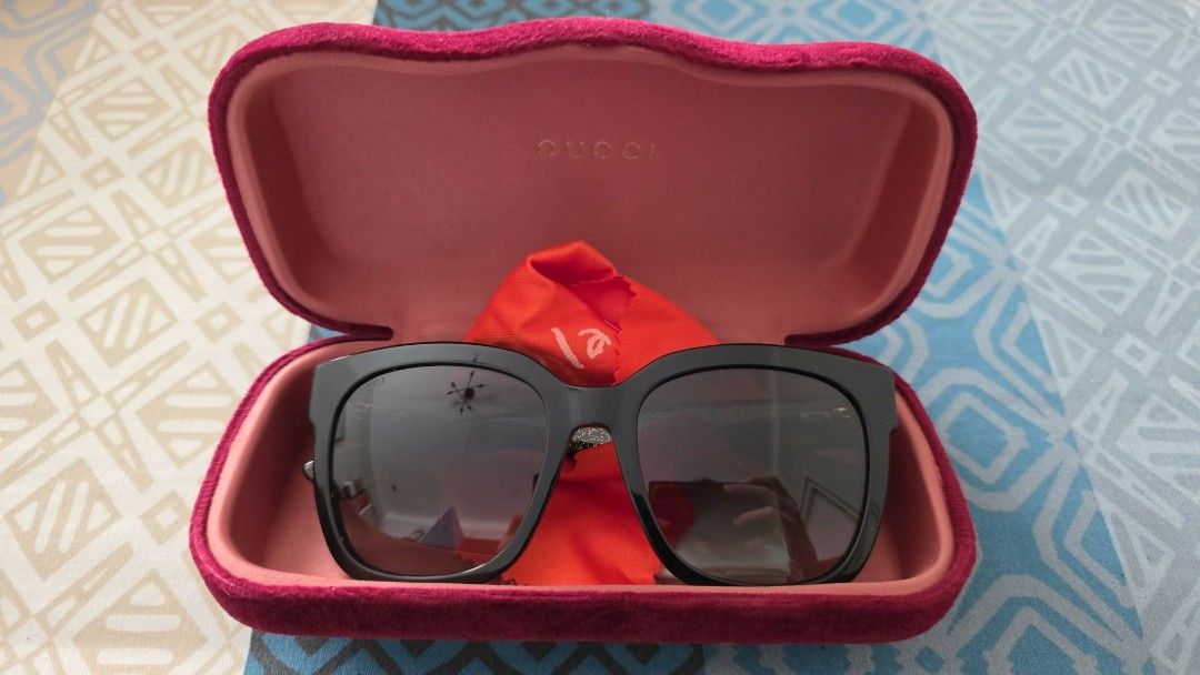 Gucci Sunglasses with Case (Category: Sunglasses & Eyewear) located in Manila. Submitted by silienat (Listing ID 1464071130, Image 1). Description: - Authentic Gucci sunglasses - Classic black frame with dark lenses - Comes with original pink velvet case - Includes original cleaning cloth - Ideal for sunny weather - Sold as is.