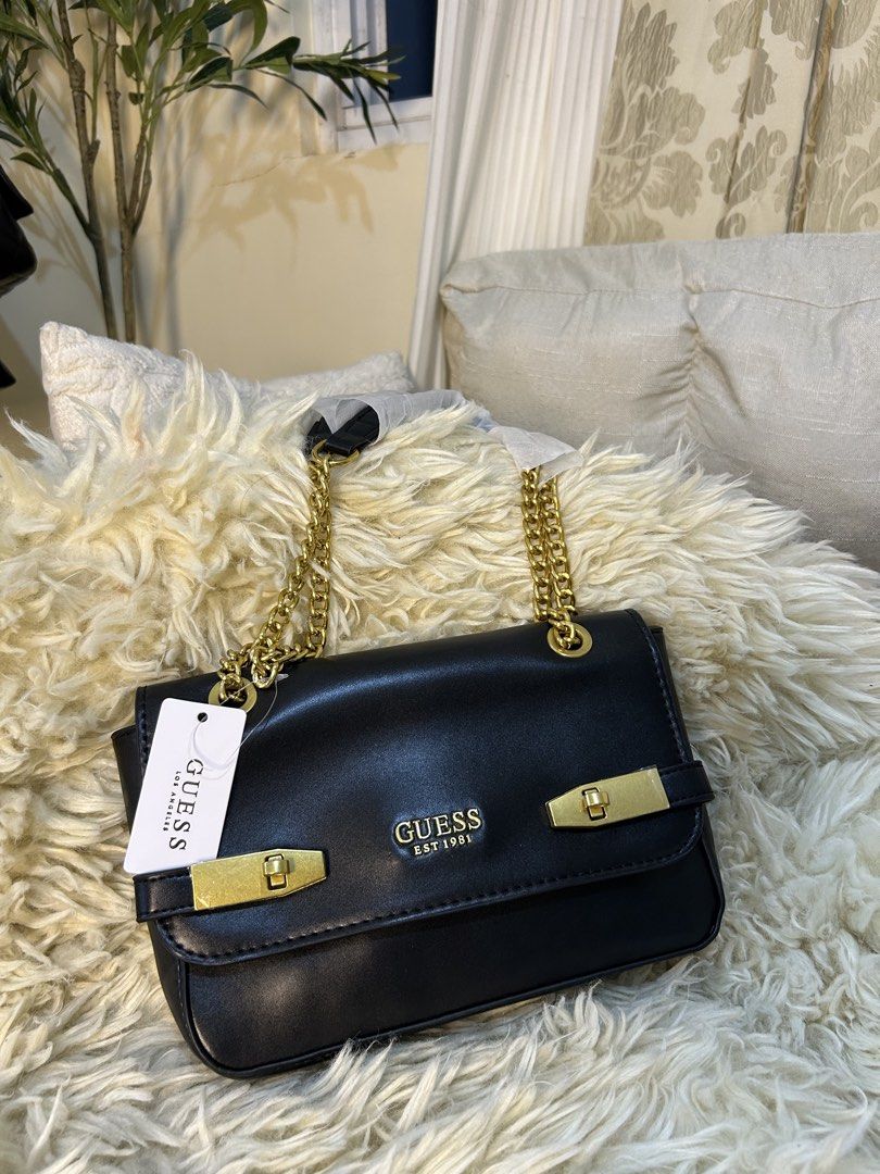 Guess Black Chain Shoulder Bag (Category: Shoulder Bags) located in Manila. Submitted by gleglessie (Listing ID 1464049899, Image 1). Description: - Stylish black Guess shoulder bag - Elegant gold chain strap - Iconic Guess Est 1981 logo on the front - Beautiful gold hardware details - Ideal size for carrying your essentials - Includes original tag.