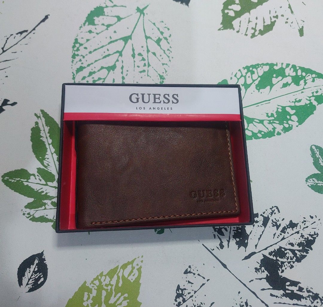 Guess Brown Leather Bifold Wallet with Box (Category: Wallets & Card holders) located in Cainta. Submitted by cooletzky (Listing ID 1463945545, Image 2). Description: - Guess brown leather bifold wallet - Ample card slots for all your essentials - Comes with original Guess box - Features embossed Guess logo on the exterior - Ideal for everyday use.