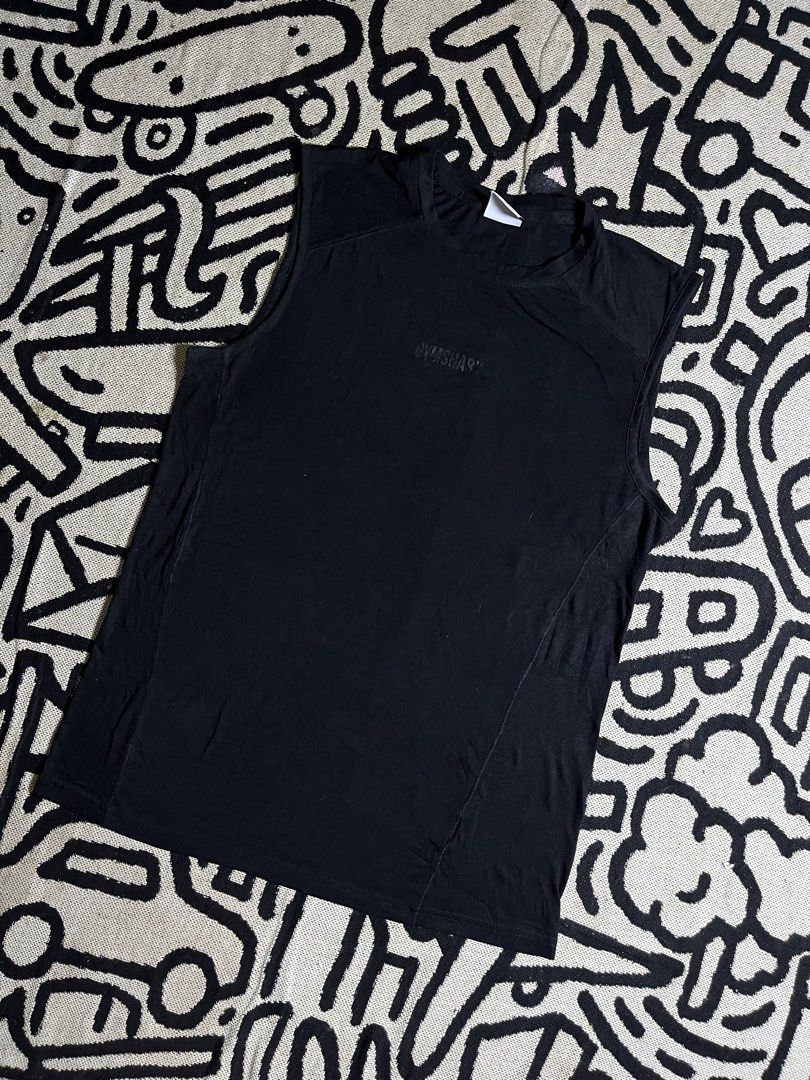 Gymshark Black Sleeveless (Category: Sleeveless) located in Silang. Submitted by yusthrift (Listing ID 1464043423, Image 1). Description: - Gymshark sleeveless top - Size: S - Color: Black - Made in: Bangladesh - Design: Simple and classic - Versatile: Great for workouts or casual wear - Condition: Please check photos for details 19 inc width 27 inc length No issue Good condition .
