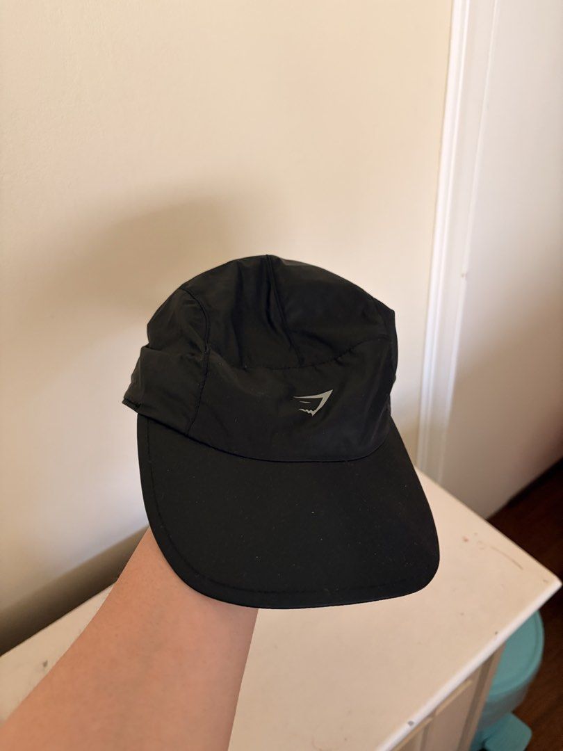 Gymshark Running Cap (Category: Caps & Hats) located in Quezon City. Submitted by rofervic (Listing ID 1464131244, Image 1). Description: - Brand: Gymshark - Color: Black - Size: One Size Fits All - Features: Adjustable strap at the back, lightweight material - Running cap - Extra Detail: Reflective detail on the back strap - Design: Clean and simple.