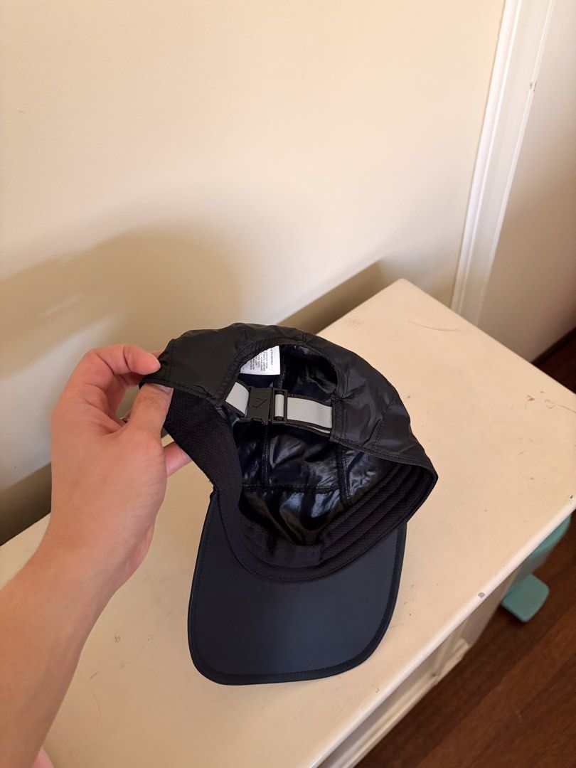 Gymshark Running Cap (Category: Caps & Hats) located in Quezon City. Submitted by rofervic (Listing ID 1464131244, Image 3). Description: - Brand: Gymshark - Color: Black - Size: One Size Fits All - Features: Adjustable strap at the back, lightweight material - Running cap - Extra Detail: Reflective detail on the back strap - Design: Clean and simple.