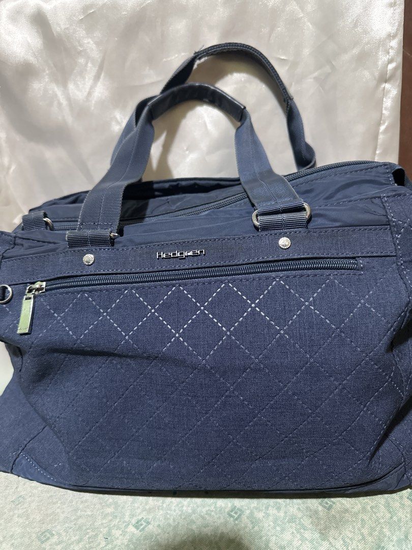 Hedgren Navy Blue Quilted Tote Bag (Category: Tote Bags) located in Balanga. Submitted by jk2025. (Listing ID 1463961693, Image 1). Description: - Navy blue Hedgren tote bag - Quilted front with diamond stitching - Two top handles - Zippered front pocket - Spacious interior for essentials - Ideal for everyday use or travel.
