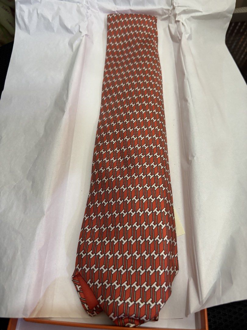 Hermes Paris Silk Tie Orange H Pattern (Category: Ties) located in Malabon City. Submitted by everythingpreloveddd (Listing ID 1464024699, Image 2). Description: - Authentic Hermes Paris tie - Made in France - Material: Silk twill - Design: Iconic H pattern in orange and white - Includes original Hermes box - Versatile for formal or casual occasions.